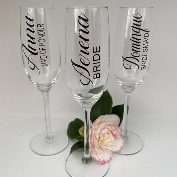 personalized bridal party champagne flutes and a flower